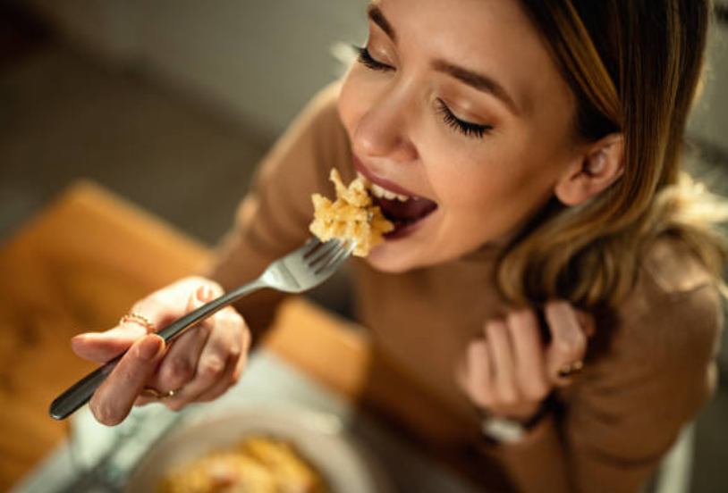 Woman enjoying a plate of pasta